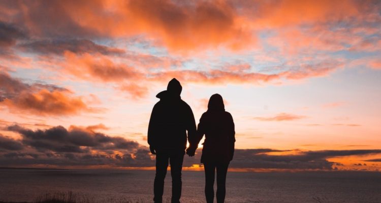 Couple holding hands in sunset | CFHP