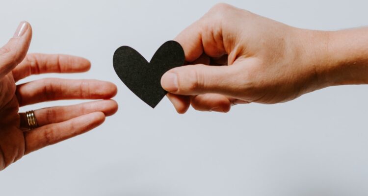Two hands holding a paper heart | CFHP