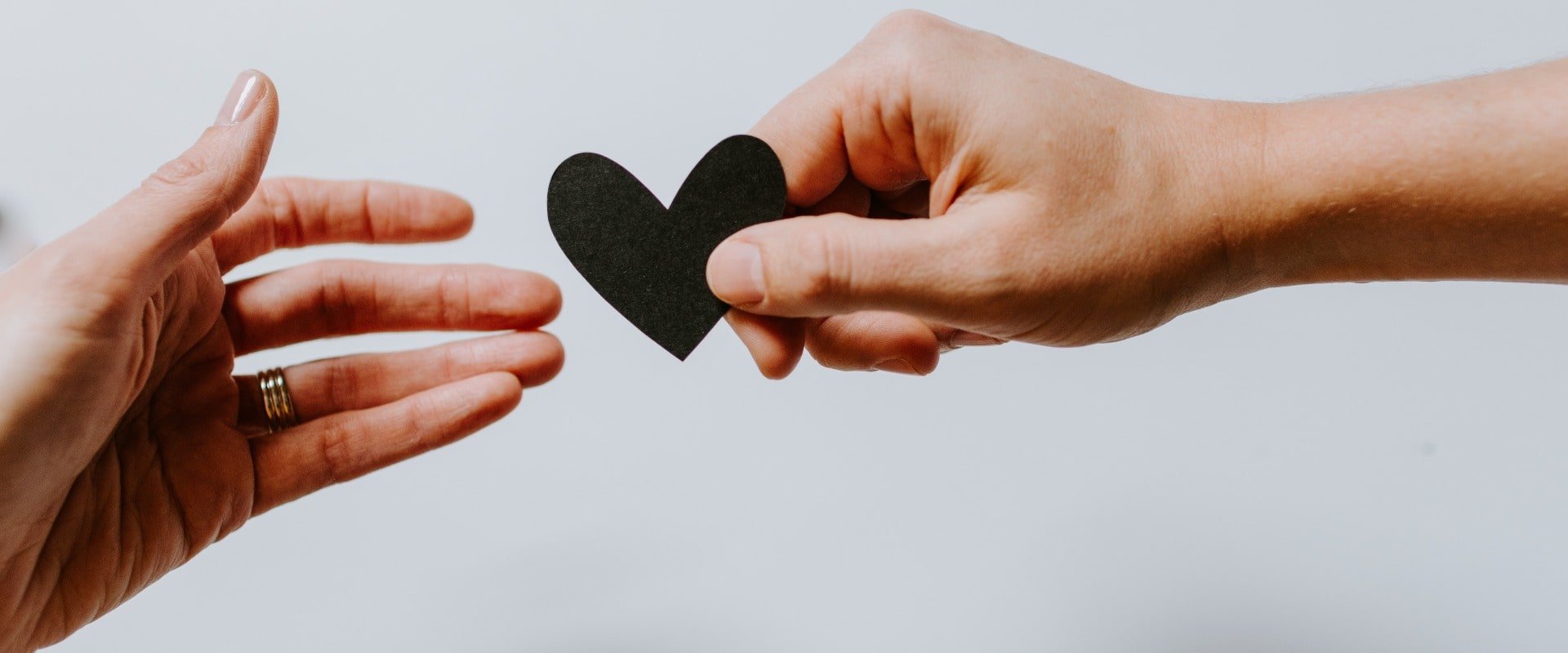 Two hands holding a paper heart | CFHP
